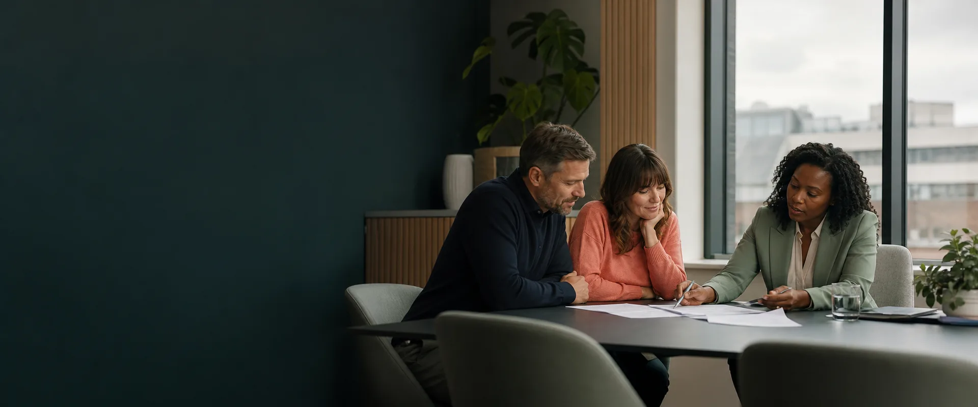 A legal adviser reviewing documents with two adult clients